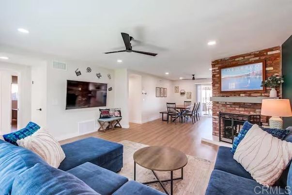 Dining room, Fireplace, Interior, Living room, Recessed Lighting, Stone Walls, Wood Texture Flooring
