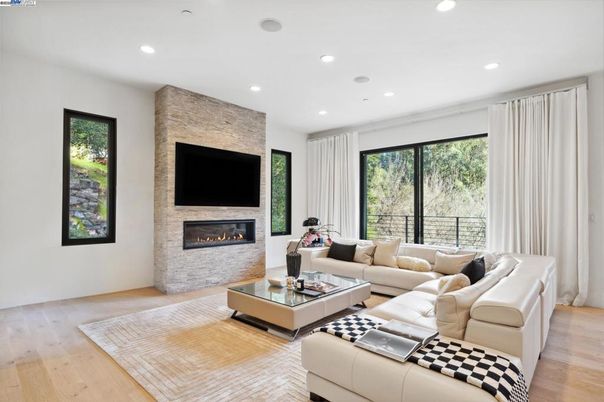 Fireplace, Interior, Living room, Recessed Lighting, Stone Walls, Wood Texture Flooring
