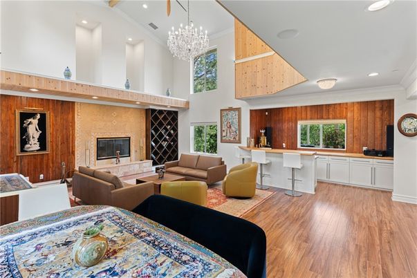 Chandelier, Fireplace, Interior, Living room, Recessed Lighting, Wood Texture Flooring, Wooden Walls