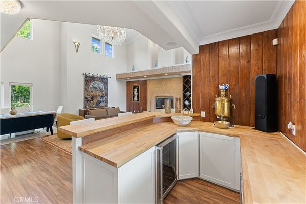 Chandelier, Fireplace, Interior, Living room, Recessed Lighting, Wood Texture Flooring, Wooden Walls