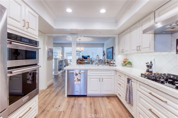 Chandelier, Dining room, Interior, Kitchen, Recessed Lighting, Stainless Steel Appliances, Wood Texture Flooring