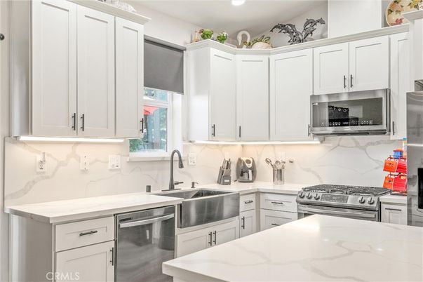 Interior, Kitchen, Marble Walls, Recessed Lighting, Stainless Steel Appliances