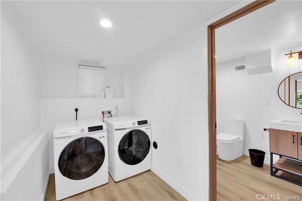 Bathroom, Dual Sink Vanities, Interior, Recessed Lighting, Washer, Wood Texture Flooring