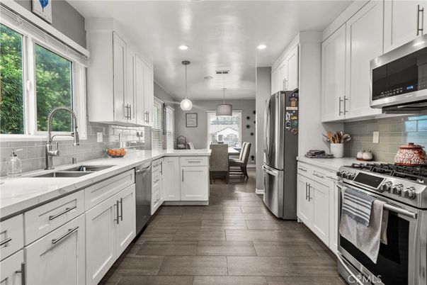 Dining room, Interior, Kitchen, Pendant Lights, Recessed Lighting, Stainless Steel Appliances, Wood Texture Flooring