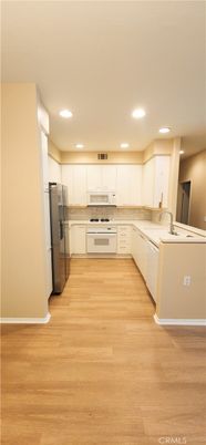 Interior, Kitchen, Recessed Lighting, Tile Countertops, Wood Texture Flooring
