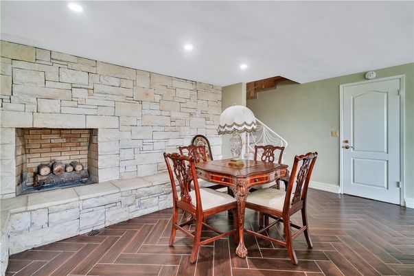 Dining room, Fireplace, Interior, Recessed Lighting, Stone Walls, Wood Texture Flooring