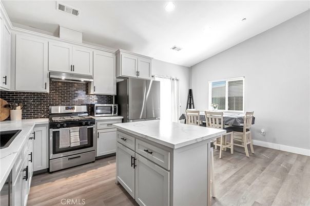 Dining room, Interior, Kitchen, Recessed Lighting, Stainless Steel Appliances, Wood Texture Flooring