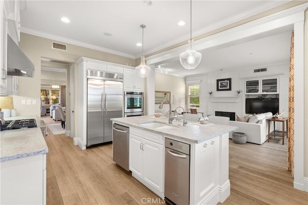 Fireplace, Interior, Kitchen, Living room, Pendant Lights, Recessed Lighting, Stainless Steel Appliances, Wood Texture Flooring