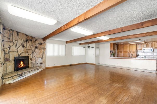 Empty room, Fireplace, Interior, Kitchen, Stone Walls, Wooden Beams, Wood Texture Flooring