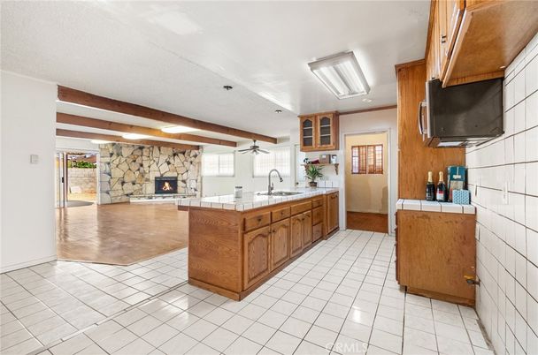 Fireplace, Interior, Kitchen, Recessed Lighting, Stone Walls, Tile Countertops