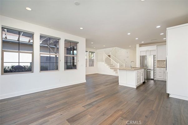 Empty room, Interior, Kitchen, Recessed Lighting, Stainless Steel Appliances, Wood Texture Flooring