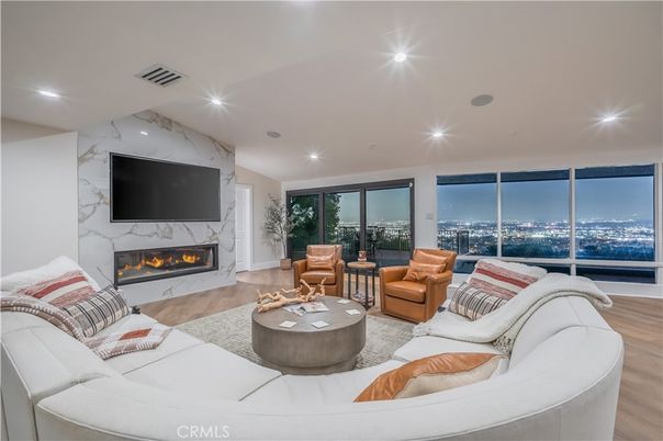 Fireplace, Interior, Living room, Marble Walls, Recessed Lighting, Wood Texture Flooring