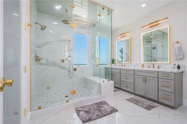 Bathroom, Dual Sink Vanities, Glass Shower, Interior, Marble, Marble Walls, Pendant Lights, Recessed Lighting