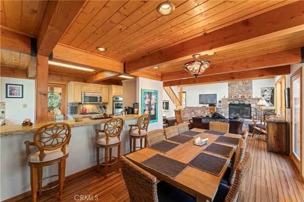Chandelier, Dining room, Fireplace, Interior, Kitchen, Living room, Recessed Lighting, Stainless Steel Appliances, Wooden Beams, Wooden Ceilings, Wood Texture Flooring