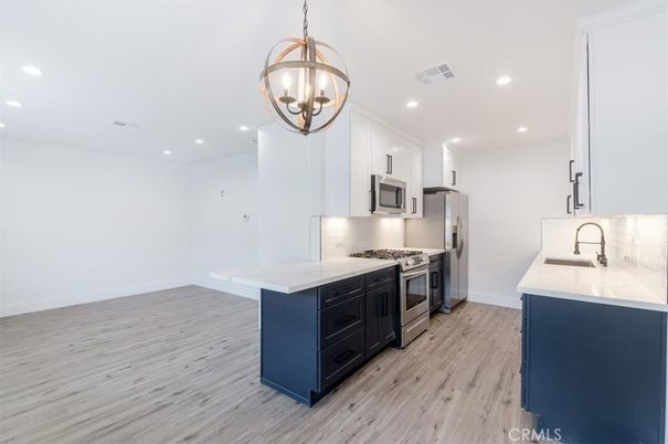 Chandelier, Interior, Kitchen, Pendant Lights, Recessed Lighting, Stainless Steel Appliances, Wood Texture Flooring