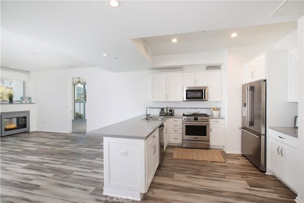Fireplace, Interior, Kitchen, Recessed Lighting, Stainless Steel Appliances, Wood Texture Flooring