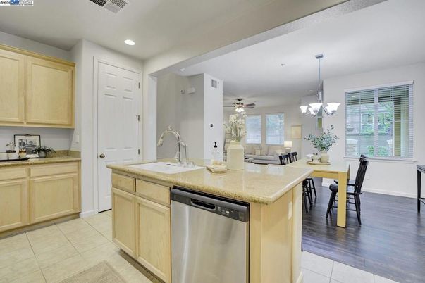 Chandelier, Dining room, Interior, Kitchen, Living room, Pendant Lights, Recessed Lighting, Stainless Steel Appliances, Wood Texture Flooring