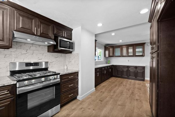 Interior, Kitchen, Marble Walls, Recessed Lighting, Stainless Steel Appliances, Wood Texture Flooring