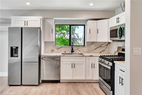 Interior, Kitchen, Marble Walls, Recessed Lighting, Stainless Steel Appliances, Wood Texture Flooring