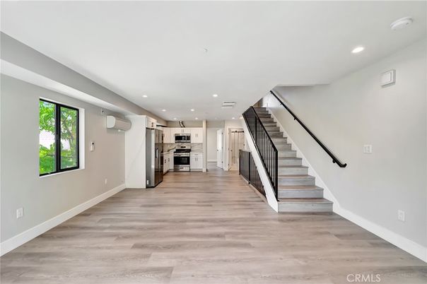 Empty room, Interior, Kitchen, Recessed Lighting, Stainless Steel Appliances, Wood Texture Flooring