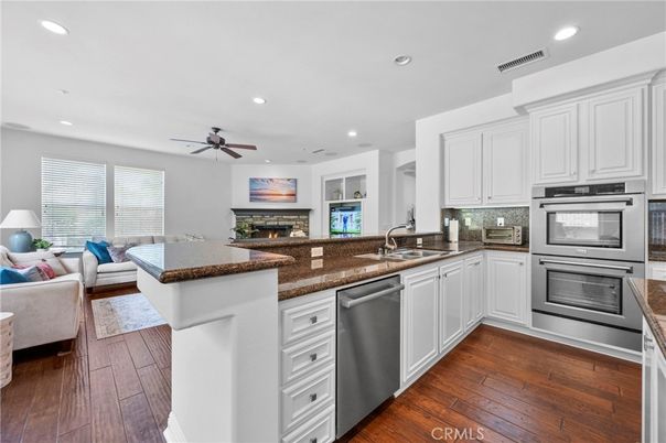 Fireplace, Interior, Kitchen, Living room, Recessed Lighting, Stainless Steel Appliances, Wood Texture Flooring