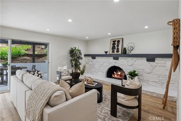 Fireplace, Interior, Living room, Recessed Lighting, Stone Walls, Wood Texture Flooring
