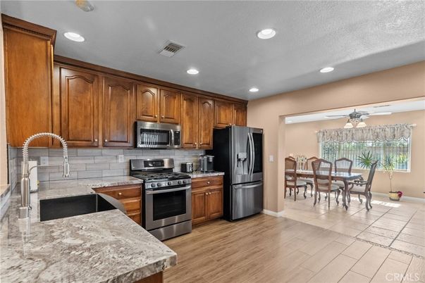 Chandelier, Dining room, Interior, Kitchen, Recessed Lighting, Stainless Steel Appliances, Wood Texture Flooring