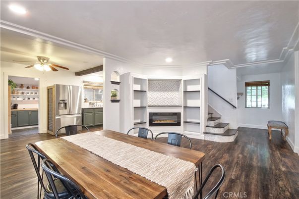 Dining room, Fireplace, Interior, Kitchen, Recessed Lighting, Stainless Steel Appliances, Wood Texture Flooring