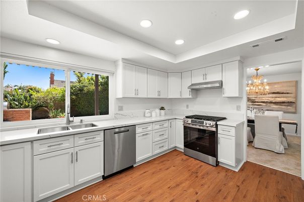 Chandelier, Dining room, Interior, Kitchen, Recessed Lighting, Stainless Steel Appliances, Wood Texture Flooring