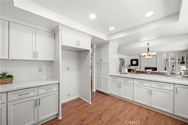Chandelier, Fireplace, Interior, Kitchen, Living room, Recessed Lighting, Wood Texture Flooring