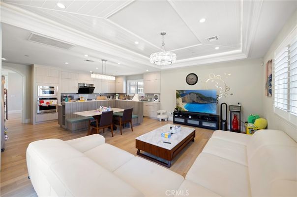Chandelier, Dining room, Interior, Kitchen, Living room, Pendant Lights, Recessed Lighting, Stainless Steel Appliances, Wood Texture Flooring