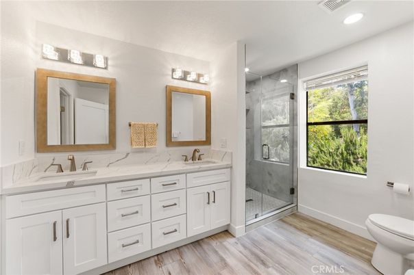 Bathroom, Dual Sink Vanities, Glass Shower, Interior, Recessed Lighting, Wood Texture Flooring