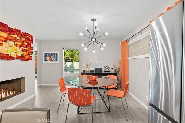 Dining room, Fireplace, Interior, Pendant Lights, Stainless Steel Appliances, Wood Texture Flooring