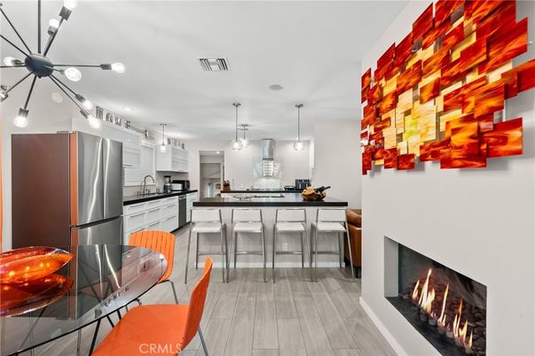 Dining room, Fireplace, Interior, Kitchen, Pendant Lights, Stainless Steel Appliances, Wood Texture Flooring