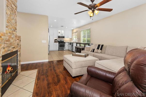 Fireplace, Interior, Kitchen, Living room, Recessed Lighting, Stainless Steel Appliances, Stone Walls, Wood Texture Flooring