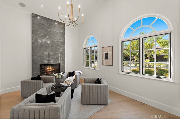 Chandelier, Fireplace, Interior, Living room, Marble Walls, Recessed Lighting, Wood Texture Flooring
