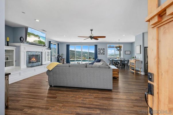 Chandelier, Dining room, Fireplace, Interior, Living room, Pendant Lights, Recessed Lighting, Wood Texture Flooring