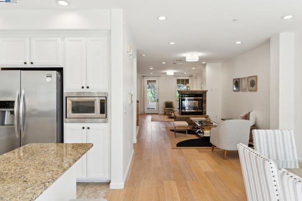 Dining room, Fireplace, Interior, Kitchen, Living room, Recessed Lighting, Stainless Steel Appliances, Wood Texture Flooring