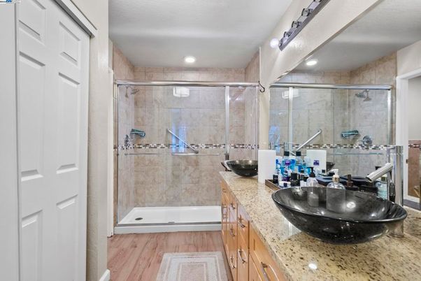Bathroom, Dual Sink Vanities, Glass Shower, Interior, Recessed Lighting, Wood Texture Flooring