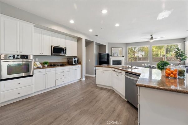 Fireplace, Interior, Kitchen, Recessed Lighting, Stainless Steel Appliances, Wood Texture Flooring