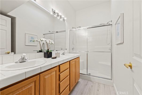Bathroom, Dual Sink Vanities, Glass Shower, Interior, Tile Countertops, Wood Texture Flooring