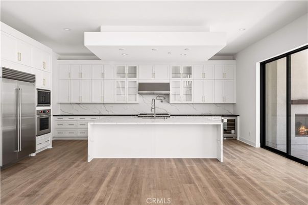 Fireplace, Interior, Kitchen, Marble Walls, Recessed Lighting, Stainless Steel Appliances, Wood Texture Flooring