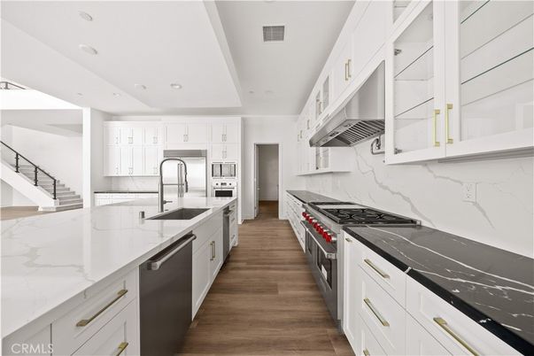 Interior, Kitchen, Marble Walls, Recessed Lighting, Stainless Steel Appliances, Wood Texture Flooring