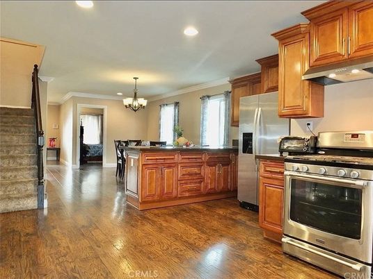 Chandelier, Dining room, Interior, Kitchen, Recessed Lighting, Stainless Steel Appliances, Wood Texture Flooring