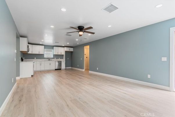 Empty room, Interior, Kitchen, Recessed Lighting, Stainless Steel Appliances, Wood Texture Flooring