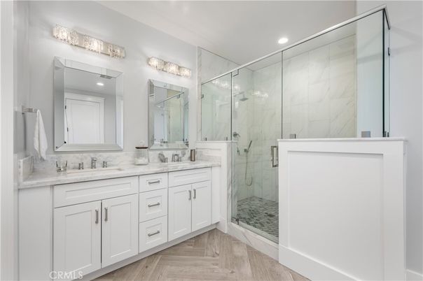Bathroom, Dual Sink Vanities, Glass Shower, Interior, Marble Walls, Recessed Lighting, Wood Texture Flooring
