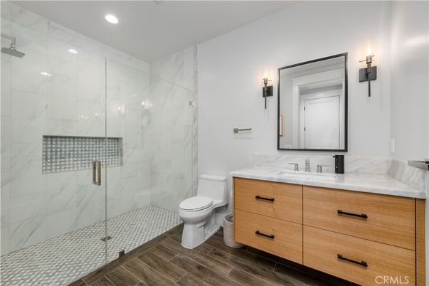 Bathroom, Glass Shower, Interior, Marble Walls, Recessed Lighting, Wood Texture Flooring
