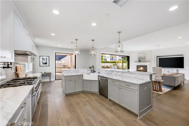 Fireplace, Interior, Kitchen, Living room, Pendant Lights, Recessed Lighting, Stainless Steel Appliances, Wood Texture Flooring