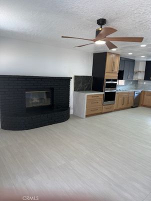 Fireplace, Interior, Kitchen, Stainless Steel Appliances, Wood Texture Flooring
