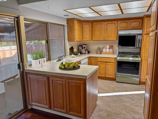 Interior, Kitchen, Stainless Steel Appliances, Tile Countertops, Wood Texture Flooring